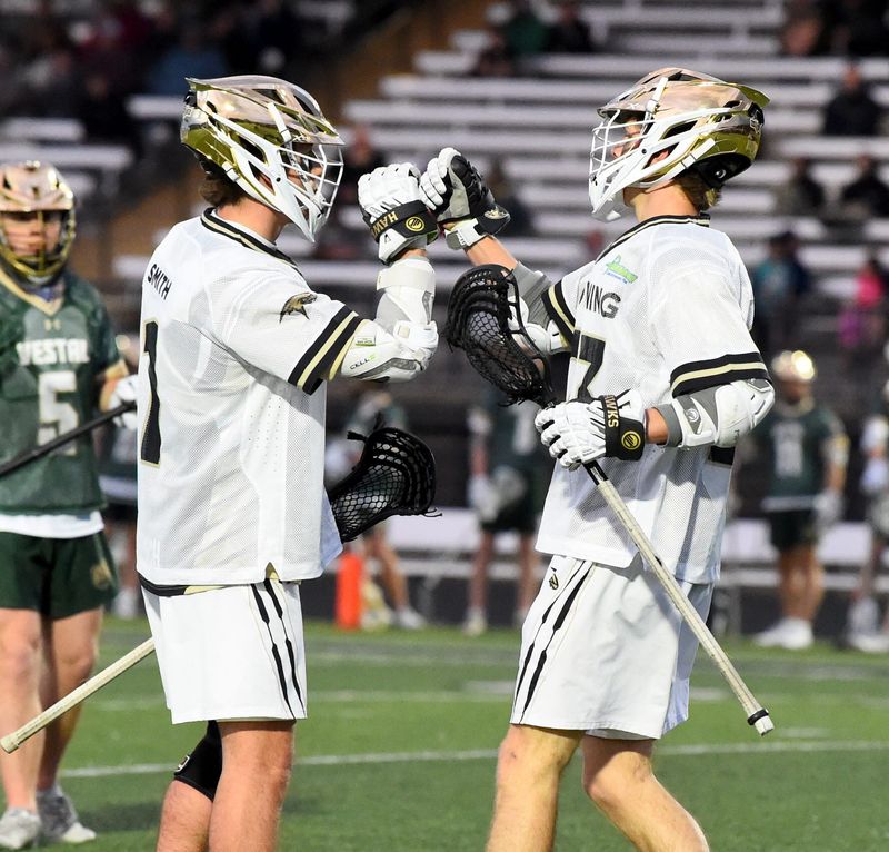 Corning's Clayton Smith, left, and Kohl Hogue celebrate a goal during a 16-3 win over Vestal in boys lacrosse April 9, 2026 at Corning Memorial Stadium. The 1990 team set the standard with the program's first state title.