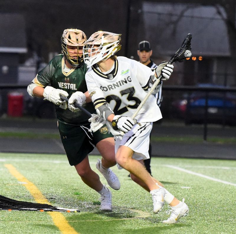 Corning's Kohl Hogue (23) controls the ball during a 16-3 win over Vestal in boys lacrosse April 9, 2026 at Corning Memorial Stadium.