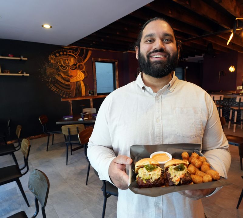 Owner Andrew Abraham with the Kerala fried chicken sliders with chaat tots at Mona, a new Indian restaurant in New Rochelle April 9, 2026.