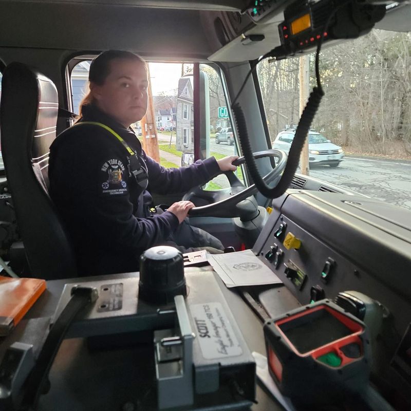 Firefighter and EMT Ashley Faubert of Ilion sits at the wheel of an Ilion Fire Department emergency vehicle; 29-y-o Faubert perished in a tragic one-vehicle crash on April 10, 2026 in Richfield.
