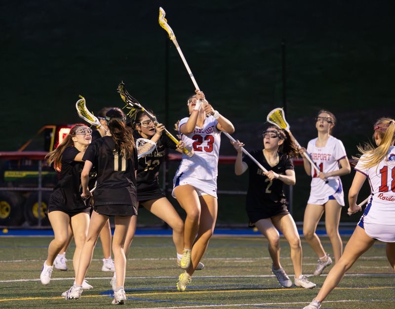 Fairport's Brinn Castrechini is surrounded by Rush-Henrietta defenders Monday, April 13 at Fairport High School.