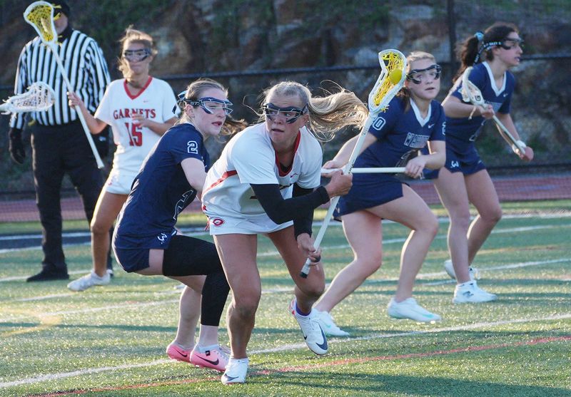 Rye’s Beau Whaling (19) looks for a path to the goal against Wilton during girls lacrosse action at Rye High School April 7, 2026. Wilton won the game 7-6.