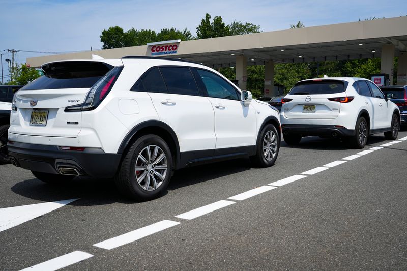 Cars wait in line to pump gas at a Costco Wholesale gas station.