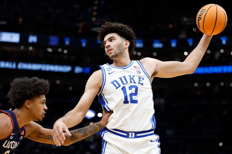 Mar 29, 2026; Washington, DC, USA; Duke Blue Devils forward Cameron Boozer (12) grabs the ball in front of UConn Huskies forward Jaylin Stewart (3) in the first half during an Elite Eight game of the East Regional of the men's 2026 NCAA Tournament at Capital One Arena. Mandatory Credit: Amber Searls-Imagn Images