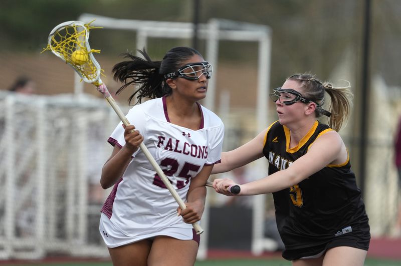 Albertus Magnus' Krisha Patel is pressured by Nanuet's Katie Kelly during their game at Albertus Magnus April 14, 2026. Albertus won 11-6.
