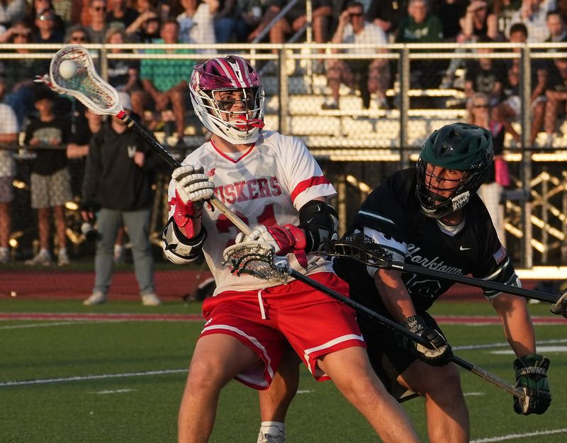 Somers’ Tristan Iglesias (21) drives to the goal against Yorktown during boys lacrosse action at Somers High School April 14, 2026. Somers won the game 9-8.