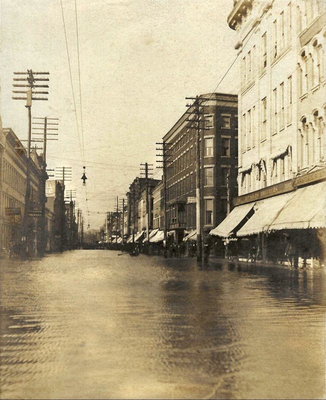 Flood waters on East Water Street in Elmira looking west on March 1, 1902. The dark building on the right is the Rathbun Hotel.