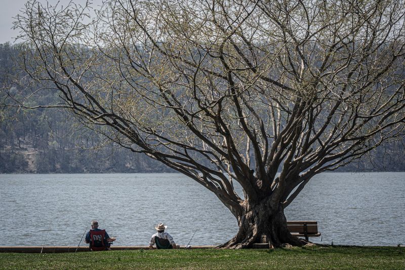 Two men relax on chairs while fishing in the Hudson River at Croton Point Park in Croton-on-Hudson April 15, 2026. Summerlike temperatures will remain in place throughout the northeast for most of the week, with meteorologists saying the heat could approach record levels in some areas.