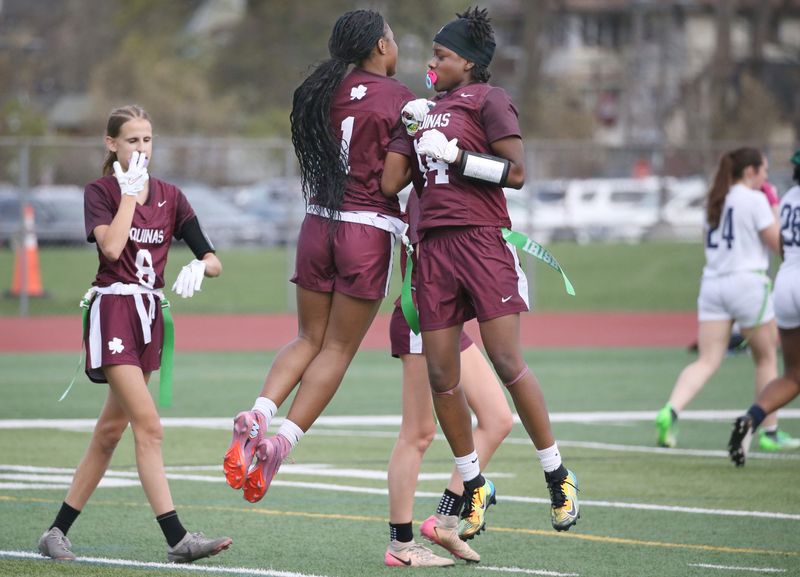 Aquinas’s Carle Thomas celebrates with teammate Bles'ng Muhammad after her interception runback for a touchdown put Aquinas up 12-0 in the second quarter during their Section V flag football game Wednesday, April 15, 2026 at Aquinas Institute.