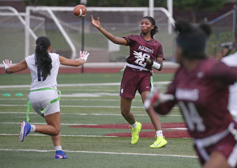 Aquinas quarterback Ajaya Orr throws downfield to sprinting wide receiver Bles'ng Muhammad in the second quarter during their Section V flag football game Wednesday, April 15, 2026 at Aquinas Institute.