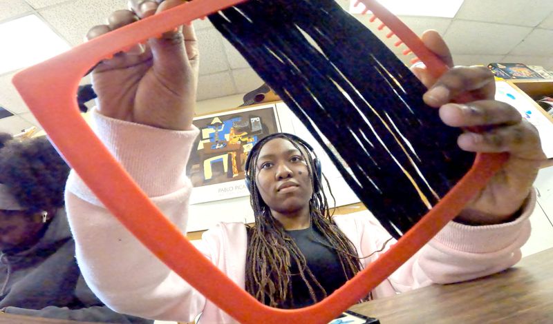 Ramapo High School student Keysha weaves a yarn panel for an art project March 24, 2026. The students were making panels for a tapestry about the rehabilitation of Spring Valley Memorial Park.