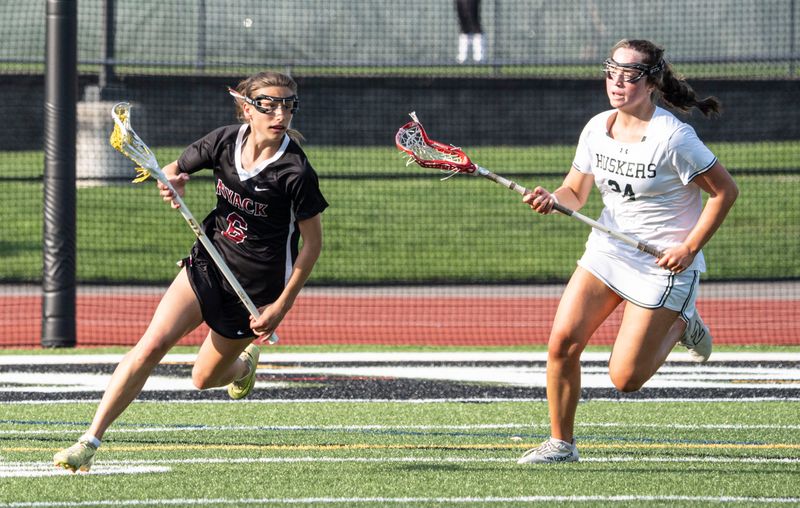 Nyack's Ava Von Kleeck drives up field against Nyack's Annie Cunneen during an April 16, 2026 girls lacrosse game.