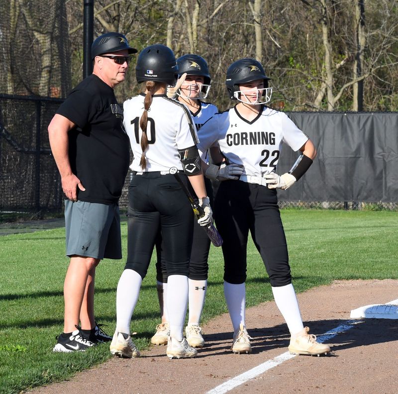 Corning head coach Mike Johnston Jr. talks to three of his players during a timeout in a 17-4, five-inning win over Elmira in a STAC softball contest April 17, 2026 at Elmira High School's Bee Stephens Softball Field.