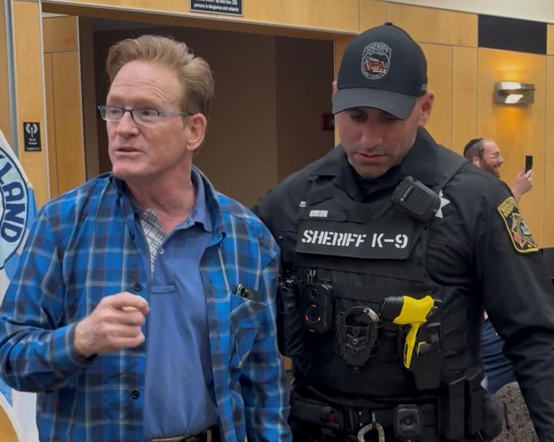 Mike Parietti, left, was escorted out of an April 14, 2026, Rockland County Legislature meeting in New City by Rockland County sheriff's deputies.