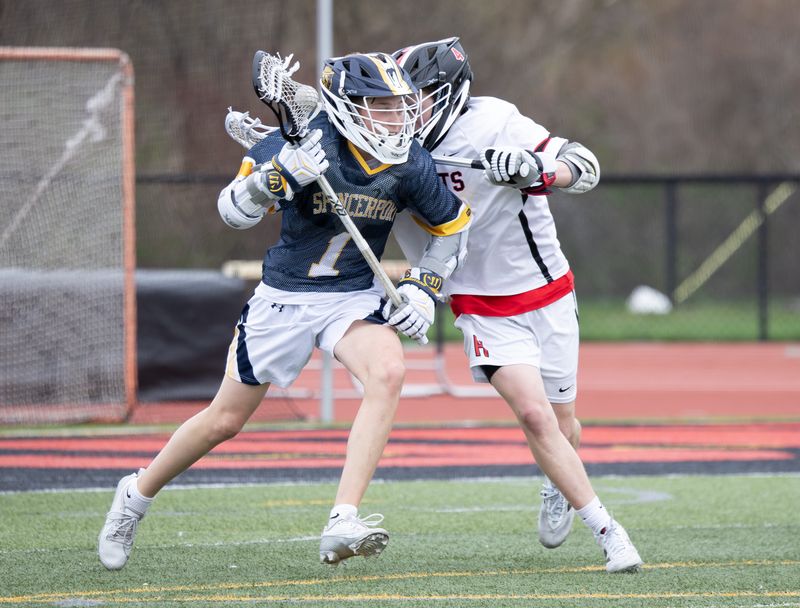 Spencerport's Mason Endres fends off Hilton's Lucas Grizzanti on Saturday, April 18 at Hilton High School.