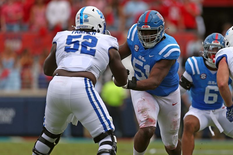 Sep 28, 2024; Oxford, Mississippi, USA; Mississippi Rebels defensive linemen Zxavian Harris (51) rushes as Kentucky Wildcats offensive lineman Jalen Farmer (52) blocks during the first half at Vaught-Hemingway Stadium. Mandatory Credit: Petre Thomas-Imagn Images