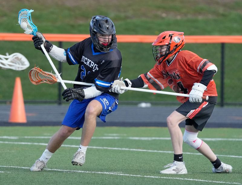 Brockport’s Tyler Davis moves around Churchville-Chili’s Joey Morgan for a shot on goal in the first quarter during their Section V boys lacrosse divisional matchup Monday, April 20, 2026 at Churchville-Chili.