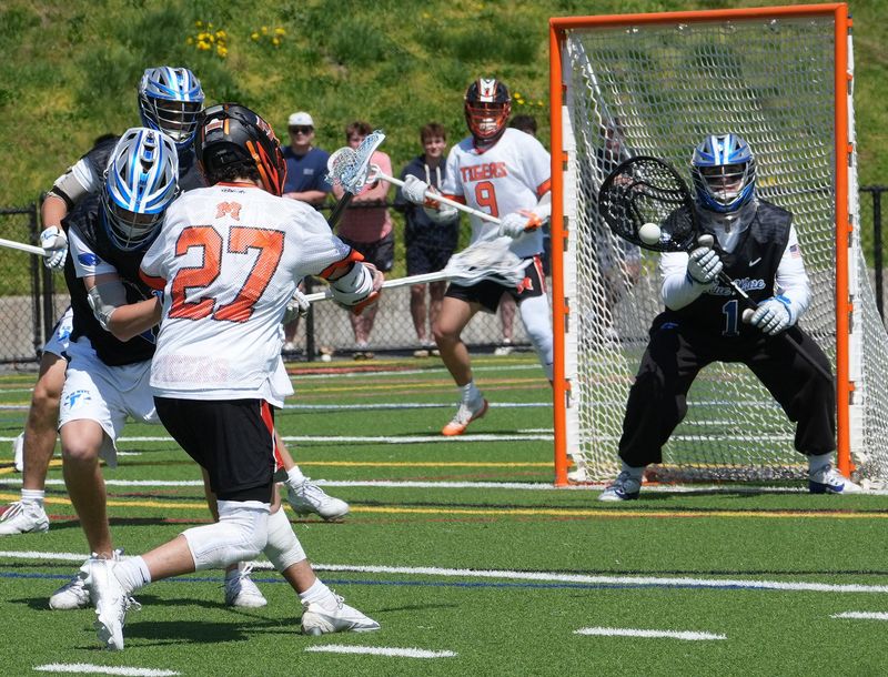 Mamaroneck’s Nate Kulish (27) fires off a shot against Darien (Connecticut) during boys lacrosse action at Mamaroneck High School April 18, 2026. Darien won the game 10-9.
