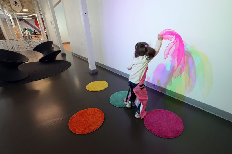 A girl dances at the color shadow wall, part of a new color in motion exhibit at the Westchester Children's Museum in Rye April 21, 2026. The museum is an interactive learning space with rotating exhibits and programs that nurture curiosity for children, families and school groups.