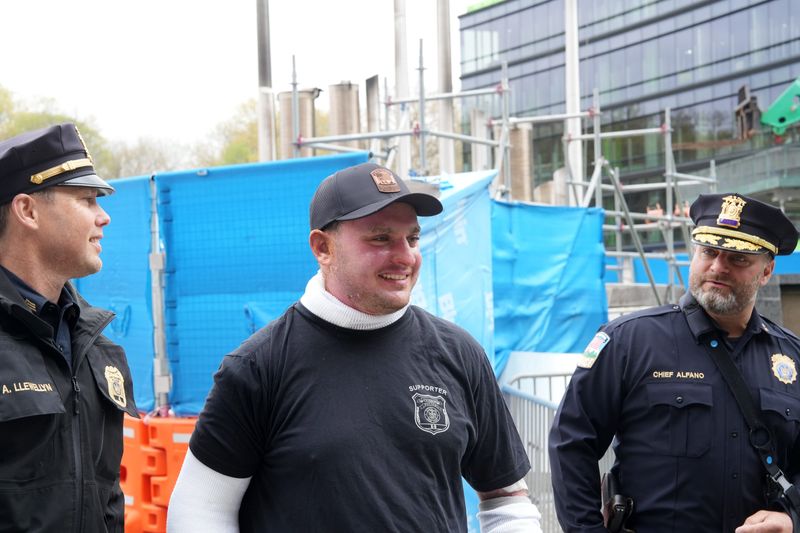 Injured Lewisboro police officer Joseph Briggs walks out of Westchester Medical Center with fellow officer Andrew Llewellyn and Chief Dave Alfano April 22, 2026. Briggs was severely burned while trying to rescue trapped residents from a house fire last week in Cross River.