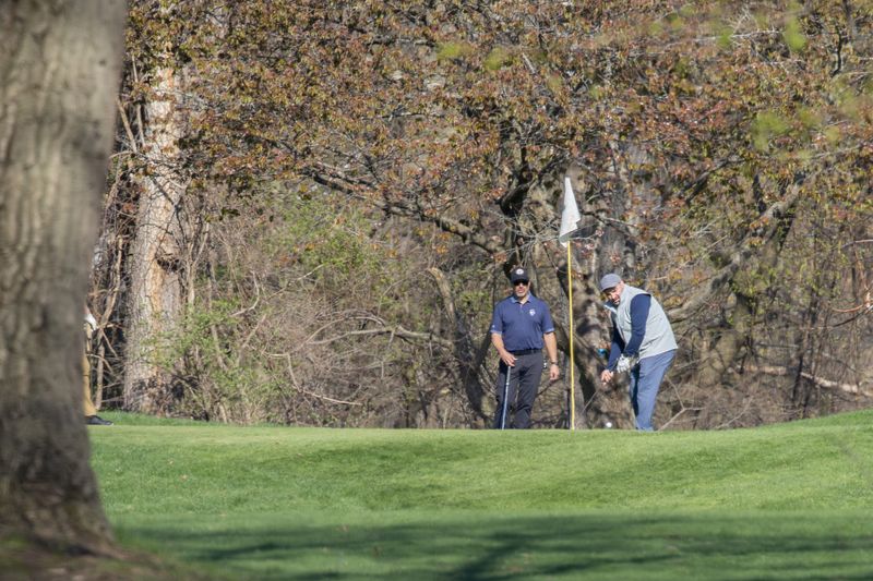 A golf watches his putt on the first hole at Durand Eastman Golf Course in Irondequoit Wednesday, April 22.