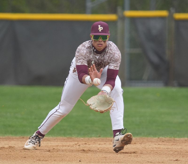 Iona Prep shortstop Julian Guzman (2) pulls in a ground ball during baseball action against Stepinac at Iona Prep High School in New Rochelle on Wednesday, April 22, 2026. Iona Prep won 11-1.