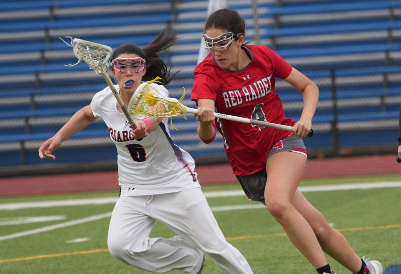 From right, North Rockland’s Sadie Essick (4) tries to get around Briarcliff’s Lily Rowe (6) during girls lacrosse action at Briarcliff High School April 22, 2026.