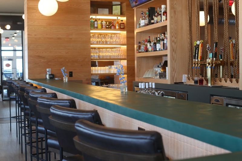 The bar at Lola’s Cocktails & Kitchen at Eastdale Village on April 24, 2026. They utilized a micro cement to create a large single piece bar in a custom color.