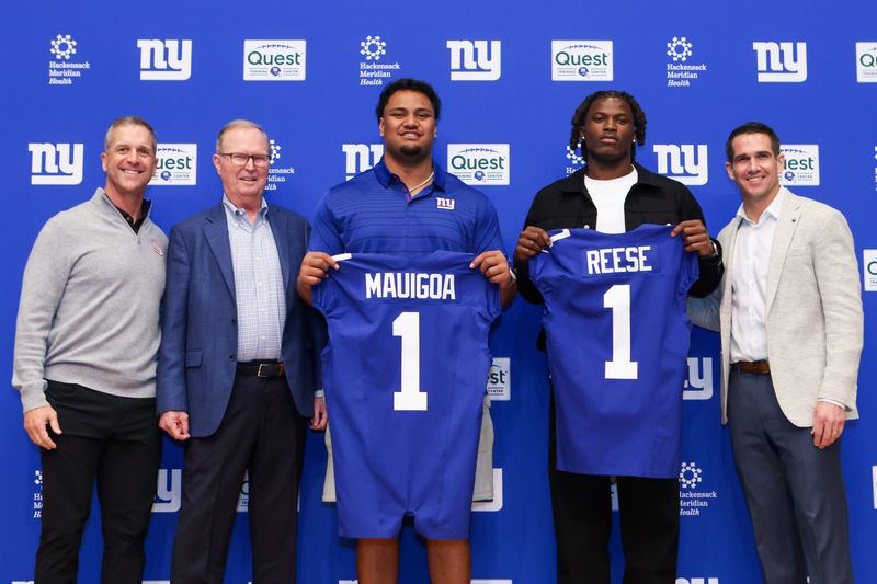 Apr 24, 2026; East Rutherford, NJ, USA; New York Giants draft picks Francis Mauigoa and Arvell Reese, Head Coach John Harbaugh (far left), Owner John Mara (left) and General Manager Joe Schoen (right) pose for a photo during the introductory press conference at Quest Diagnostics Training Center. Mandatory Credit: Tom Horak-Imagn Images