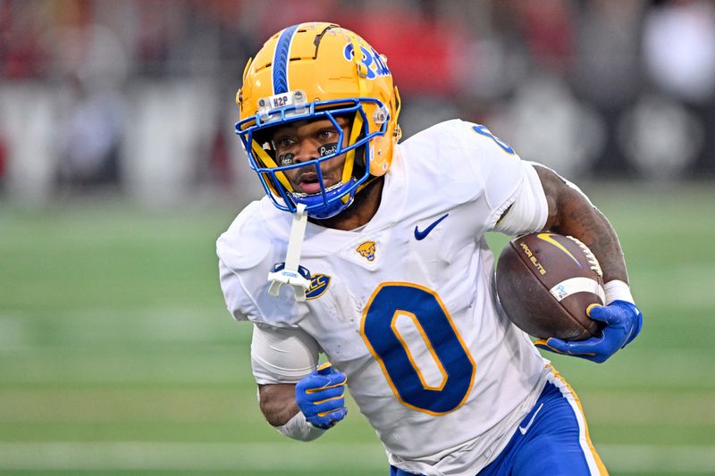 Nov 23, 2024; Louisville, Kentucky, USA; Pittsburgh Panthers running back Desmond Reid (0) runs against the Louisville Cardinals during the first quarter at L&N Federal Credit Union Stadium.