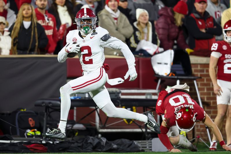 Dec 19, 2025; Norman, OK, USA; Alabama Crimson Tide defensive back Zabien Brown (2) eludes a tackle by Oklahoma Sooners quarterback John Mateer (10) in the first half at Gaylord Family OK Memorial Stadium. Mandatory Credit: Mark J. Rebilas-Imagn Images
