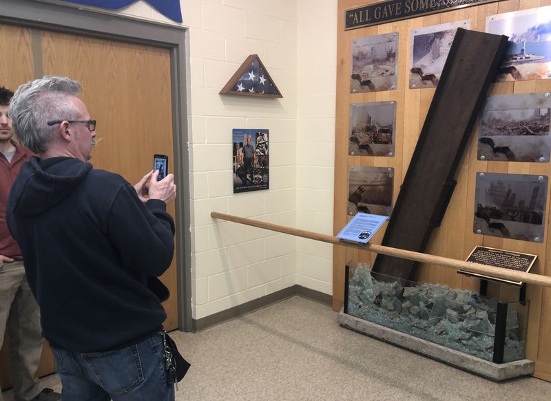 David Sorrells takes a photo of the 9-11 memorial created by the late Fishers Fire Chief Andy Stromfeld. The memorial is now housed at the Cnandaigua Fire Department's No. 1 firehouse.