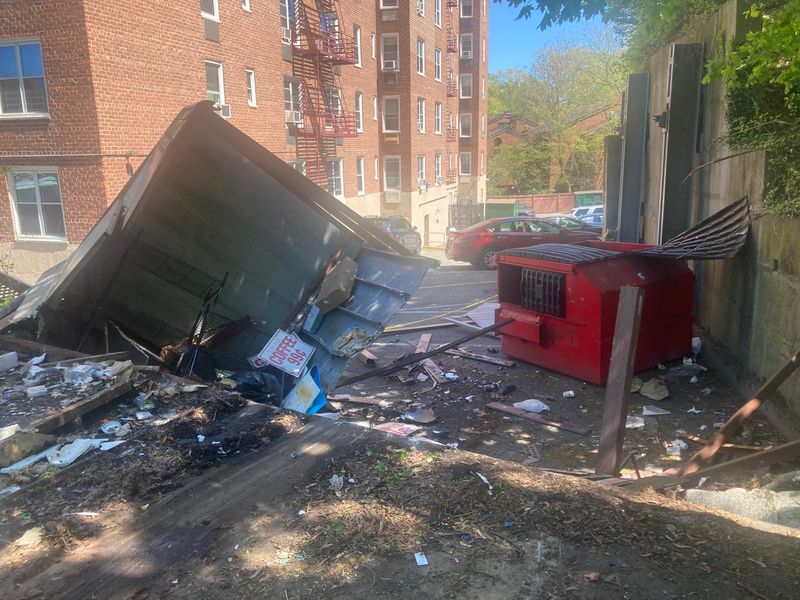 A Dumpster, a storage shed and a fence damaged at the Mobil gas station at Kimball and Midland avenues in Yonkers when an SUV carjacked from a New York State trooper pumping gas crashed into them on April 26, 2026. Photo taken April 27, 2026.