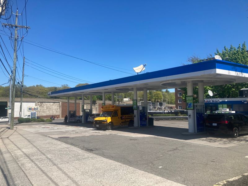 The Mobil gas station at Kimball and Midland avenues in Yonkers on April 27, 2026, the day after a New York state trooper had her SUV carjacked when she finished pumping gas. She shot the carjacker, who then drove the SUV into a Dumpster, a storage shed and a fence behind the gas station.