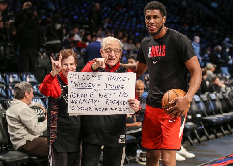 Mar 8, 2020; Brooklyn, New York, USA; Chicago Bulls forward Thaddeus Young (21) with Brooklyn Nets fans Bruce "Mr. Whammy" Reznick and his wife Judy during pregame warmups at Barclays Center. Mandatory Credit: Wendell Cruz-USA TODAY Sports