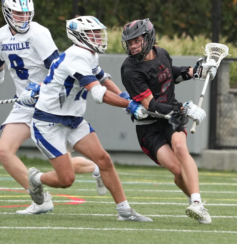 Bronxville's Connor Mestl pressures a shot by Rye's Will Niejadlik during their game at Bronxville. April 27, 2026. Rye won 11-5.