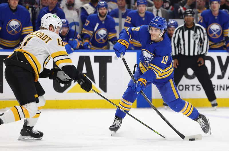 Boston Bruins center Casey Mittelstadt tries to block a shot by Buffalo Sabres center Peyton Krebs during overtime in game five of the first round of the 2026 Stanley Cup Playoffs at KeyBank Center. es