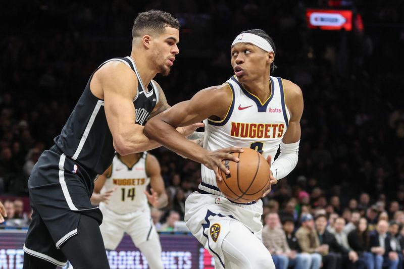 Jan 4, 2026; Brooklyn, New York, USA; Denver Nuggets guard Peyton Watson (8) looks to drive past Brooklyn Nets forward Michael Porter Jr. (17) in the first quarter at Barclays Center. Mandatory Credit: Wendell Cruz-Imagn Images