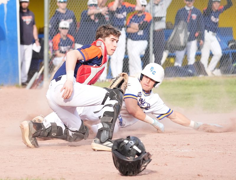 Mahopac's Vince Cataldo (10) slides in to home beating a tag by Horace Greeley catcher Luca Polizzi (2) during baseball action at Mahopac Falls School on Wednesday, April 29, 2026. Mahopac won 2-0.