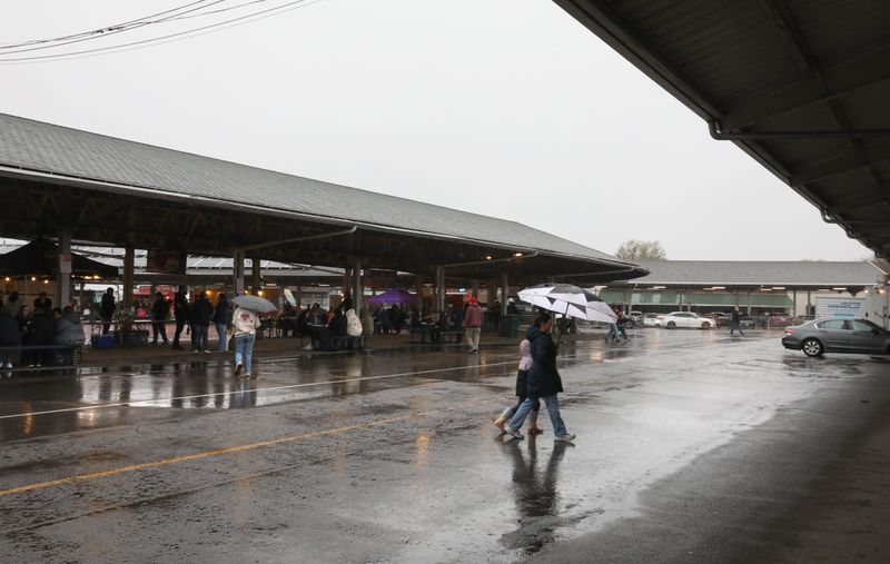 A steady stream of customers, with umbrellas in hand, attended the first-of-the-season Food Truck Rodeo held at the City of Rochester Public Market Wednesday, April 29, 2026 on a cool and rainy night.