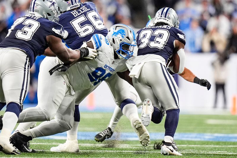 Detroit Lions defensive tackle DJ Reader (98) tackles Dallas Cowboys running back Javonte Williams (33) during the first half at Ford Field in Detroit on Thursday, Dec. 4, 2025.