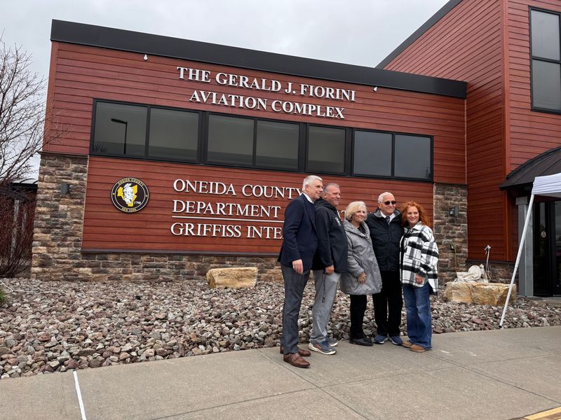 Former Board of Legislators Chairman Gerald J. Fiorini stands with his family and County Executive Anthony J. Picente Jr. after the unveiling of the renaming of the Oneida County Aviation Complex in honor of Fiorini in Rome, NY on Thursday, April 30, 2026.