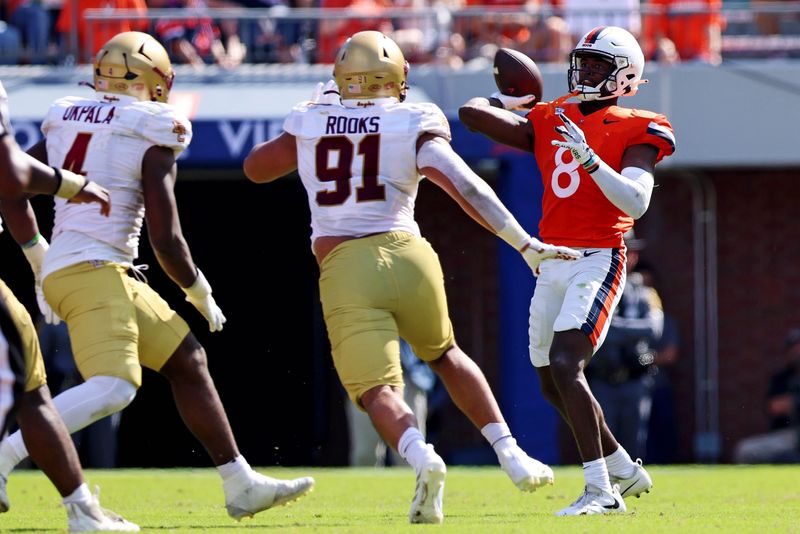 Oct 5, 2024; Charlottesville, Virginia, USA; Virginia Cavaliers wide receiver Malachi Fields (8) throws a pass against Boston College Eagles defensive lineman George Rooks (91) during the third quarter at Scott Stadium. Mandatory Credit: Peter Casey-Imagn Images