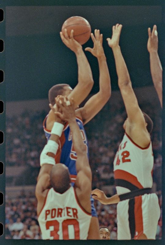 06/10/1990; Portland, Oregon, USA; Pistons'' James Edwards takes the ball to the net with Trailblazers' Wayne Cooper and Joe Craig Porter try to block the shot in the third game of the NBA Finals, Mandatory Credit: Craig Porter, Detroit Free Press, USA Today Network