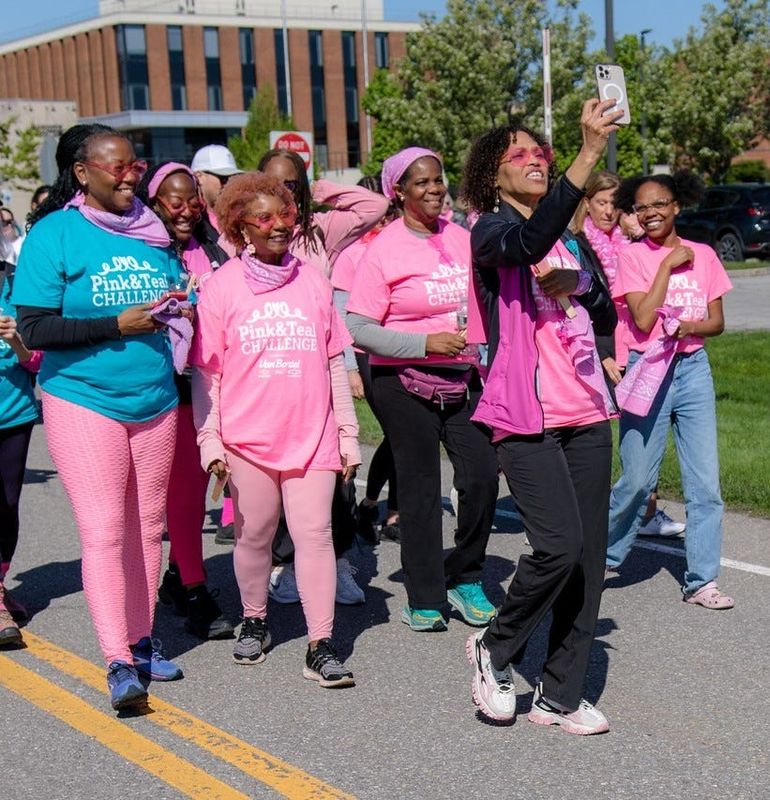 Nicolette Ferguson, at center holding her cell phone, and her team "Life's Dancers" participate in the 2025 Pink & Teal Challenge. Nicolette is a breast cancer survivor, and one of the Breast Cancer Coalition of Rochester's Emerging Leaders, a group that supports the coalition's research Initiative and advocacy efforts. .