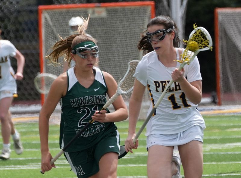 Pelham’s Colleen Sheehy’s (11) drives to the goal against Minisink Valley during girls lacrosse action at Glover Field in Pelham May 2, 2026. Pelham won the game 21-7.