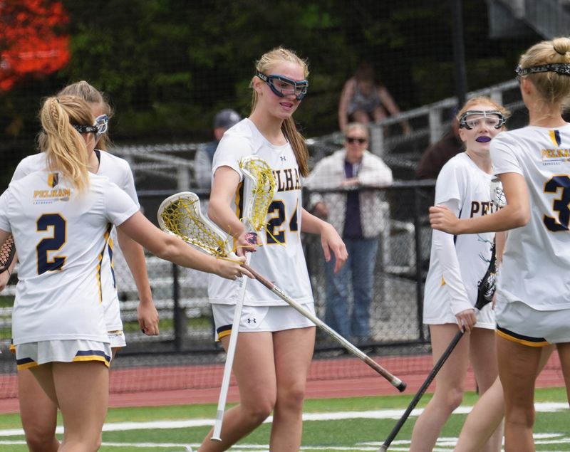 Pelham teammates Parker Koupal, left, and Brooke Green celebrate after a goal against Minisink Valley during a May 2, 2026 girls lacrosse game.