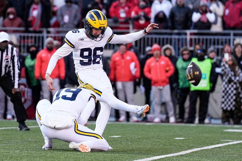 Michigan place kicker Dominic Zvada (96) scores a field goal against Ohio State as Tommy Doman (19) holds the ball during the second half at Ohio Stadium in Columbus, Ohio on Saturday, Nov. 30, 2024.
