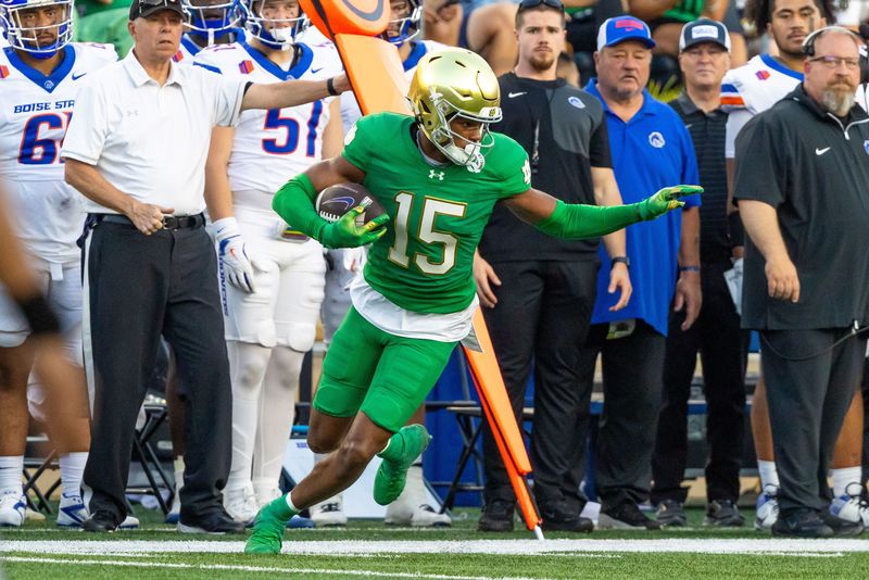 Oct 4, 2025; South Bend, Indiana, USA; Notre Dame Fighting Irish cornerback Leonard Moore (15) comes up with an interception against the Boise State Broncos at Notre Dame Stadium. Mandatory Credit: Michael Caterina-Imagn Images
