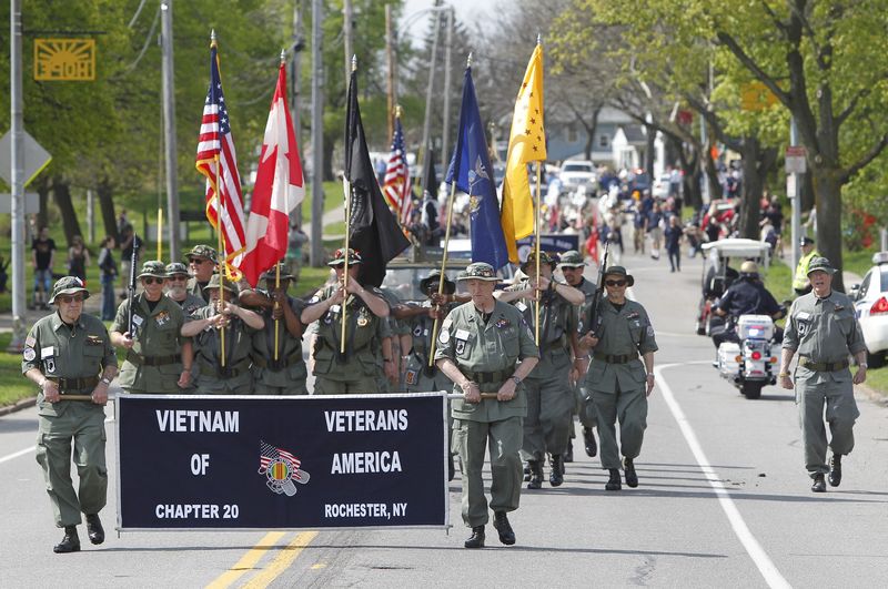 A group of Vietnam Veterans get the parade kicked off during the parade and opening weekend of the Lilac Festival in Rochester Saturday morning, May 10, 2014.
